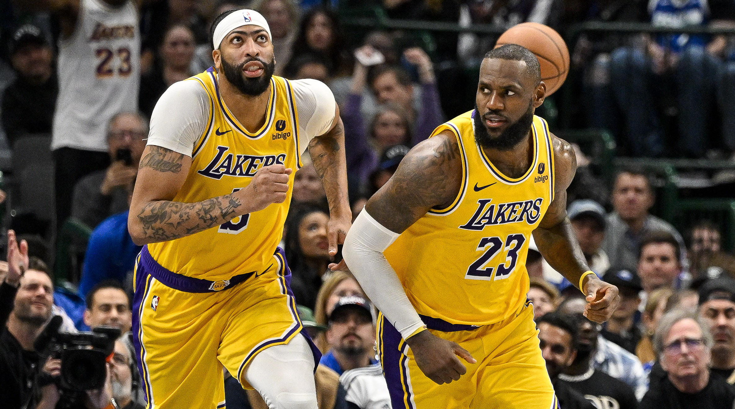 Lakers forwards Anthony Davis, left, and LeBron James run down the court